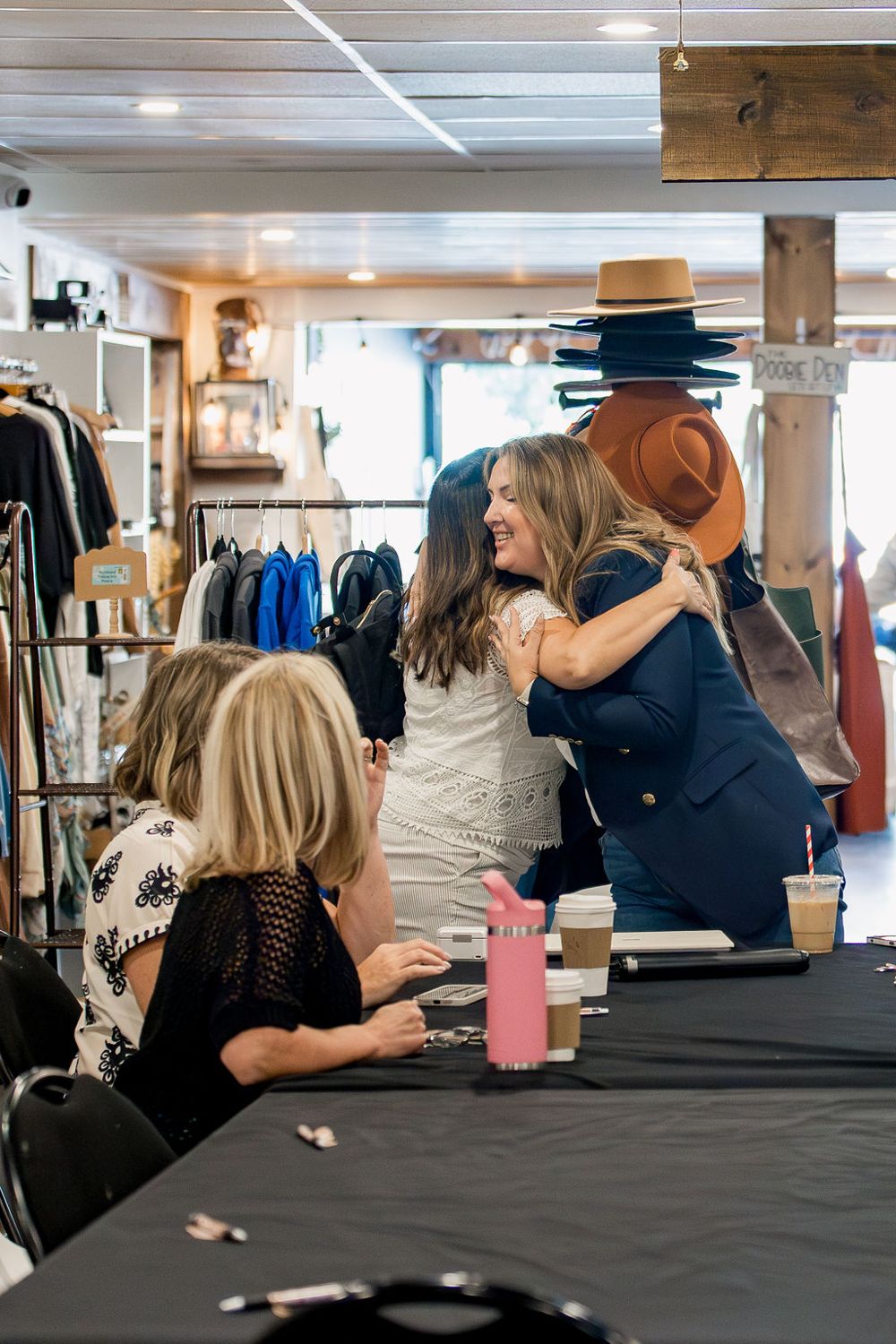 Two members hugging at a We Rise gathering